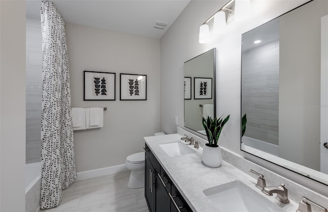 full bathroom featuring toilet, vanity, shower / bath combination with curtain, and tile patterned flooring