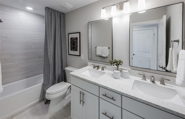 full bathroom featuring shower / bath combo, vanity, and toilet