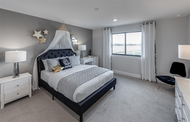 bedroom featuring light colored carpet