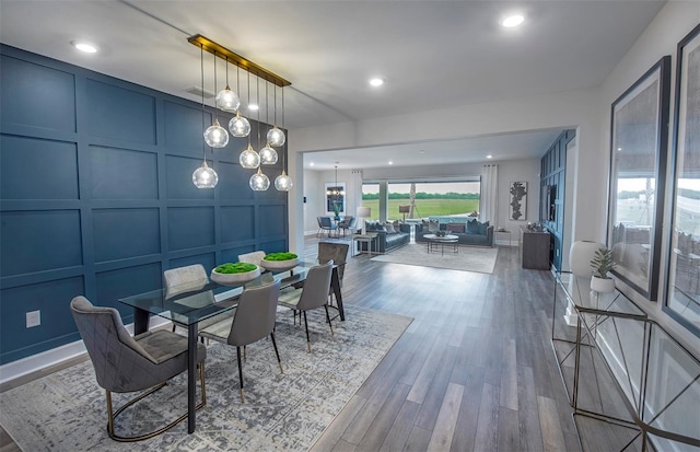 dining space featuring wood-type flooring