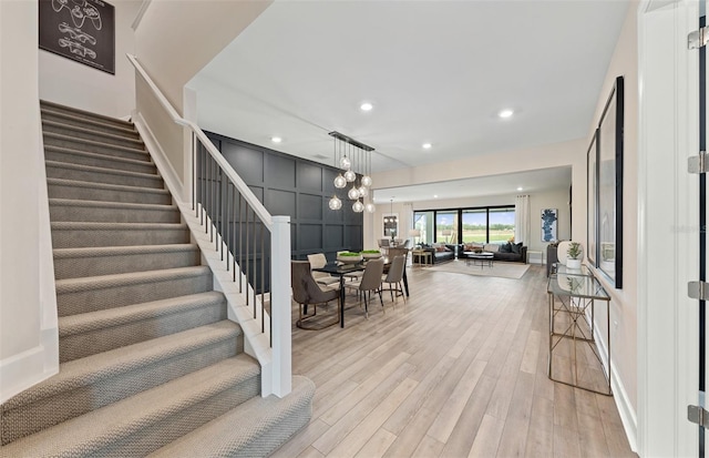 stairs featuring hardwood / wood-style floors