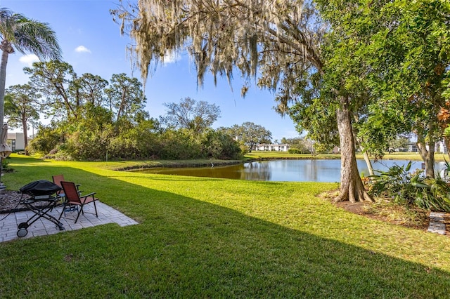 view of yard with a patio area and a water view