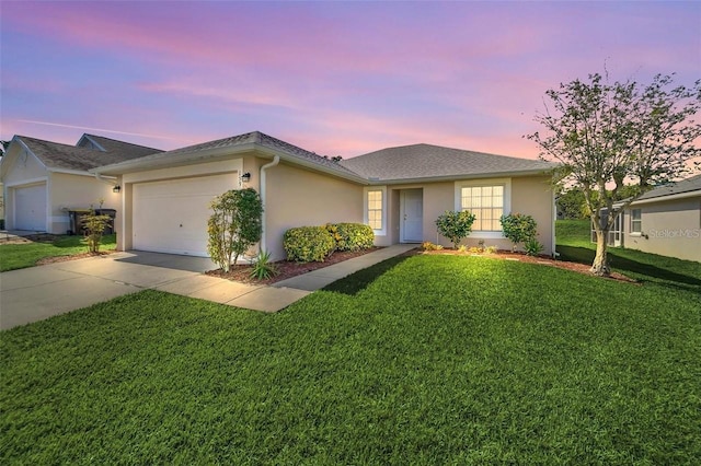 ranch-style house featuring a lawn and a garage