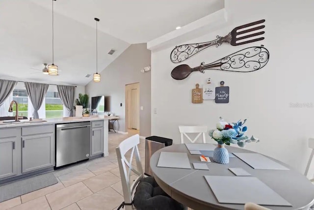 kitchen featuring ceiling fan, sink, stainless steel dishwasher, pendant lighting, and light tile patterned flooring