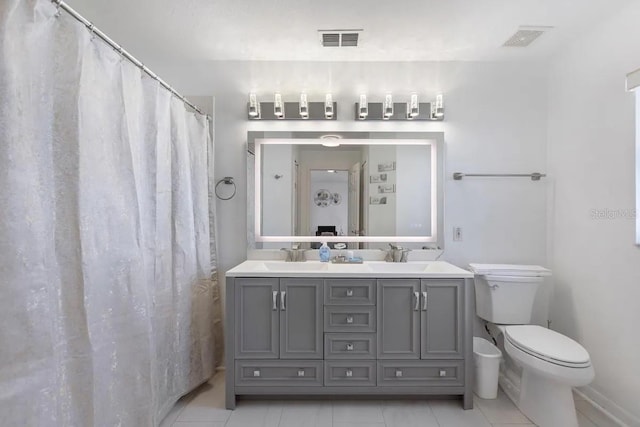 bathroom with curtained shower, tile patterned flooring, vanity, and toilet