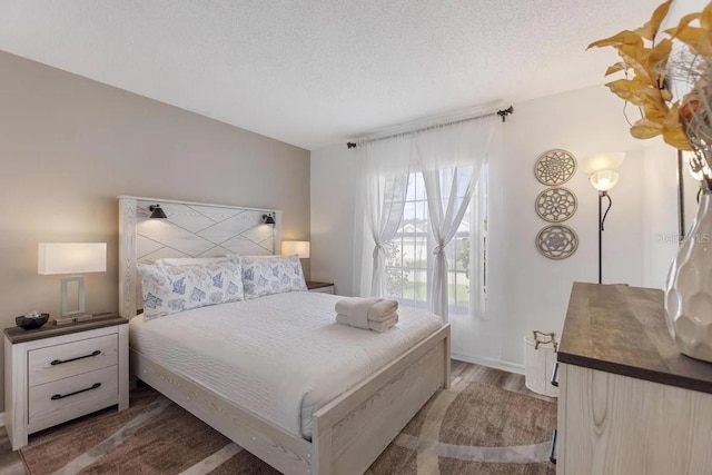 bedroom featuring a textured ceiling and dark wood-type flooring