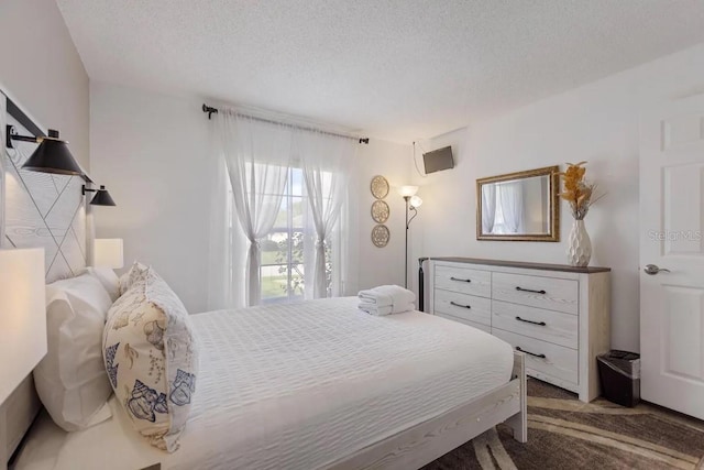 carpeted bedroom with a textured ceiling