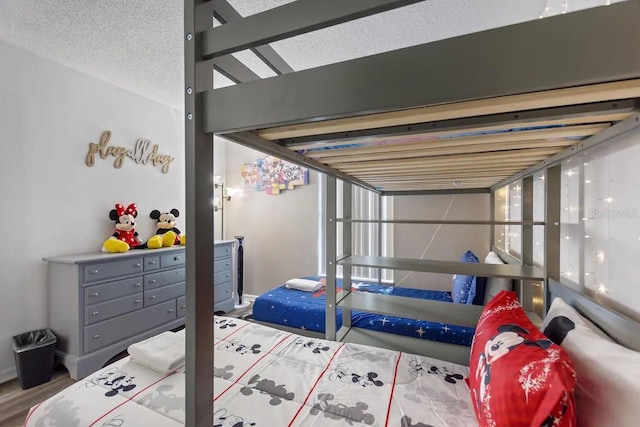 bedroom featuring a textured ceiling and hardwood / wood-style flooring