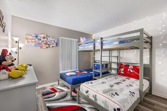 bedroom featuring dark hardwood / wood-style flooring and a textured ceiling