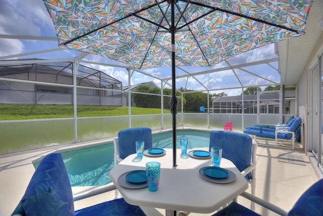 view of pool featuring glass enclosure, a patio area, a water view, and a hot tub