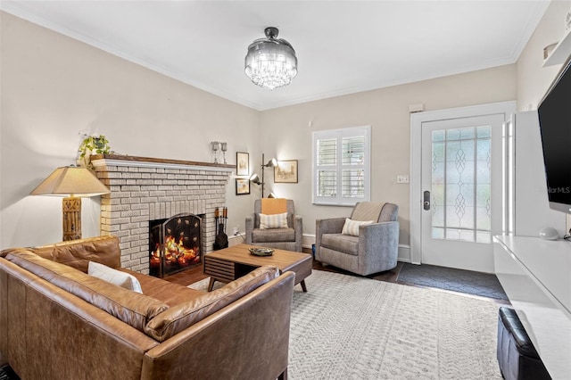 living room with a fireplace, a chandelier, and crown molding