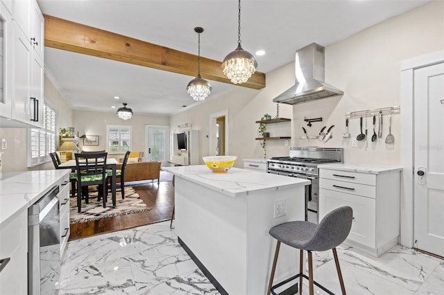 kitchen with a center island, white cabinetry, high end range, and extractor fan