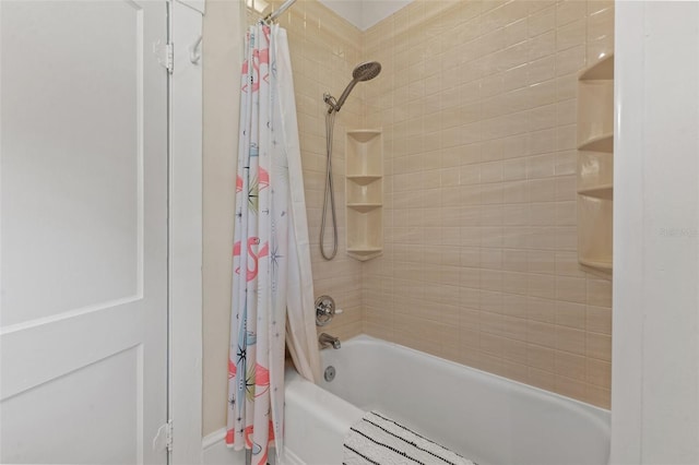 bathroom with radiator and shower / bath combo with shower curtain