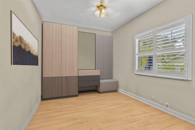 unfurnished bedroom with ceiling fan and light hardwood / wood-style floors