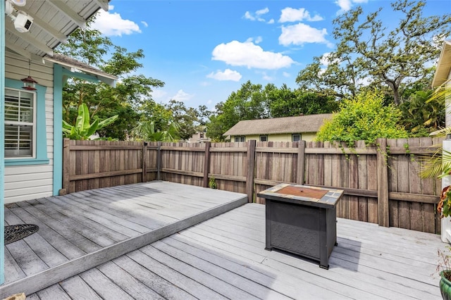 wooden deck with a fire pit