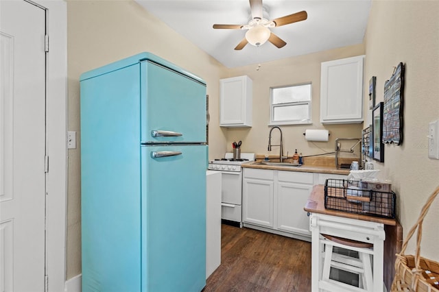 kitchen featuring white cabinets, refrigerator, dark wood-type flooring, and sink