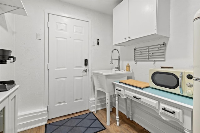 clothes washing area with hardwood / wood-style floors