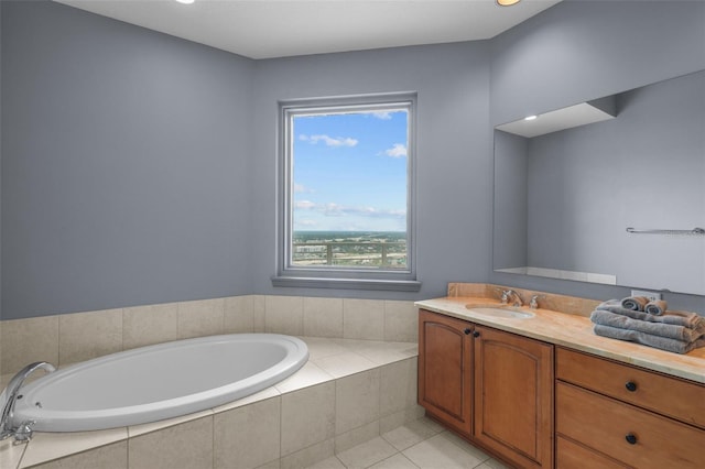 bathroom with a relaxing tiled tub, tile patterned flooring, and vanity