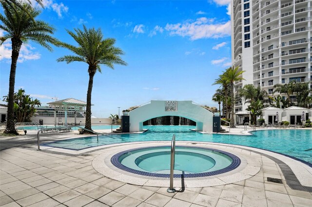 view of pool with a hot tub