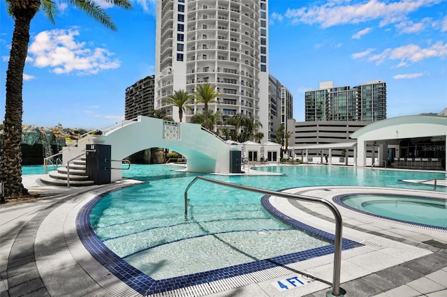 view of swimming pool featuring a community hot tub