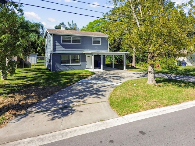 view of front of home featuring a carport and a front yard