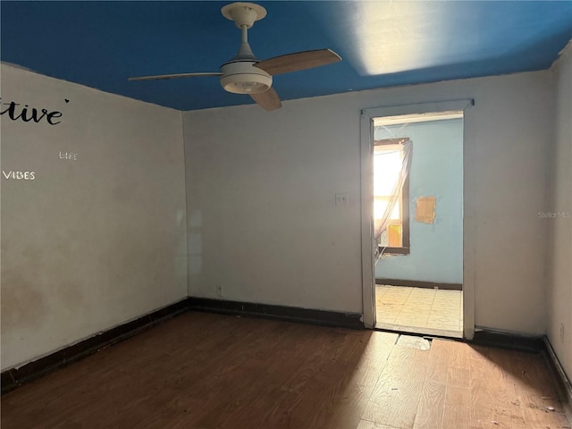 spare room featuring hardwood / wood-style floors and ceiling fan