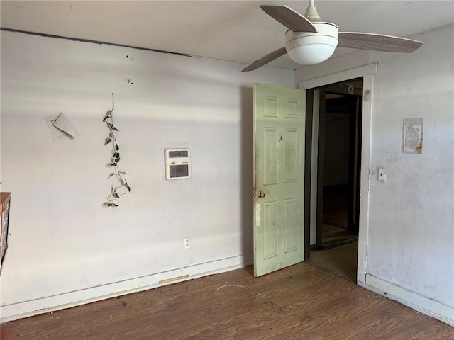 spare room featuring ceiling fan and dark hardwood / wood-style floors