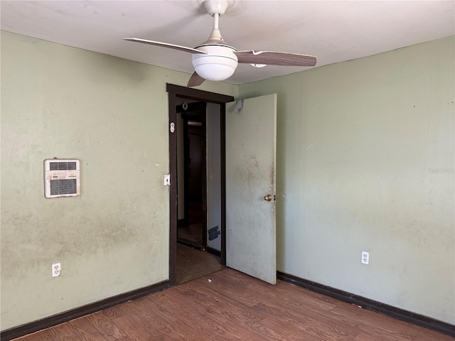 unfurnished room with ceiling fan and dark wood-type flooring