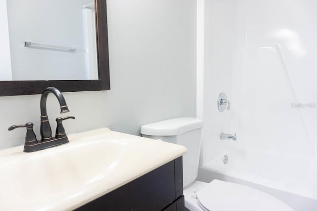 bathroom featuring toilet, vanity, and shower / tub combination