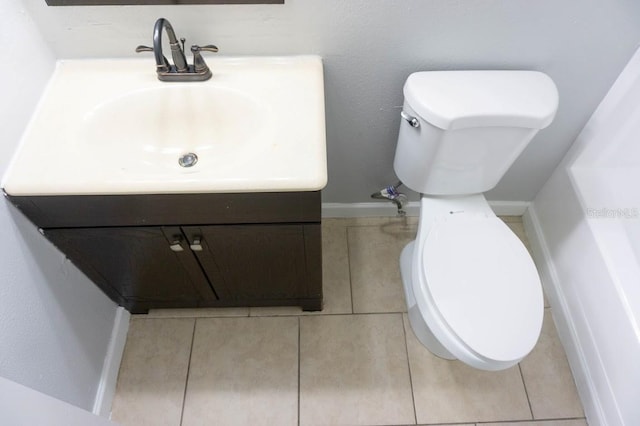 bathroom featuring vanity, tile patterned floors, and toilet