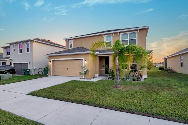 view of front of home featuring a garage and a yard