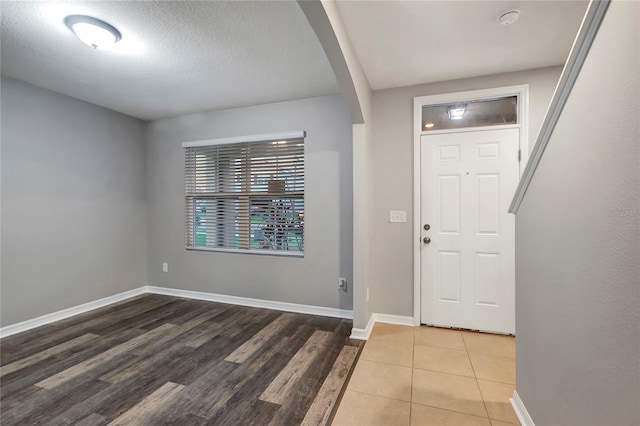 entryway with a textured ceiling and hardwood / wood-style flooring