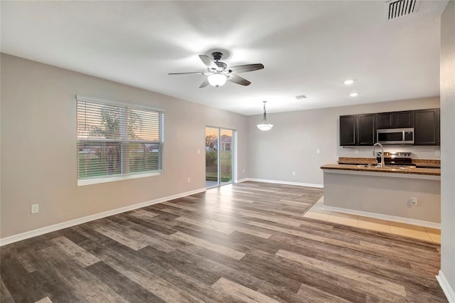 interior space with sink, hardwood / wood-style flooring, and ceiling fan