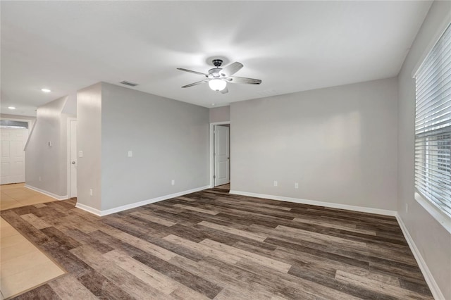 empty room with hardwood / wood-style floors and ceiling fan