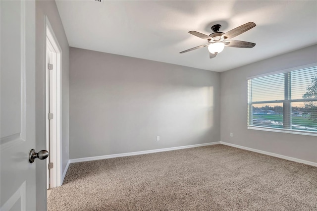 carpeted empty room featuring ceiling fan