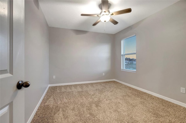 spare room featuring ceiling fan and carpet floors