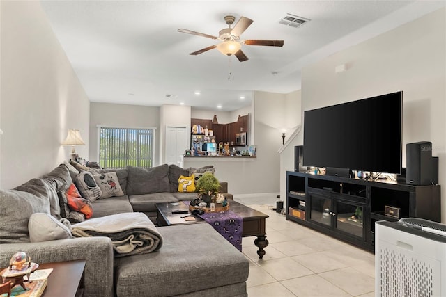 tiled living room featuring ceiling fan