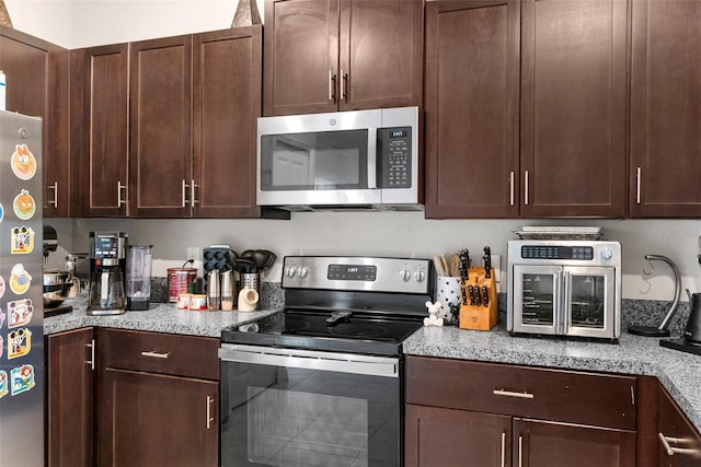 kitchen featuring dark brown cabinets and appliances with stainless steel finishes