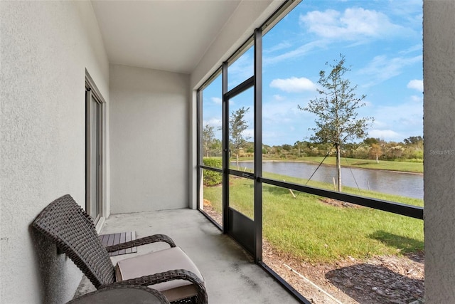 sunroom / solarium featuring a water view