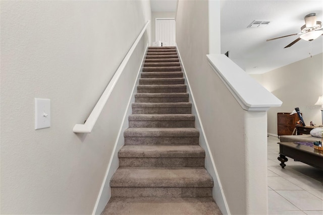 stairway with tile patterned flooring and ceiling fan