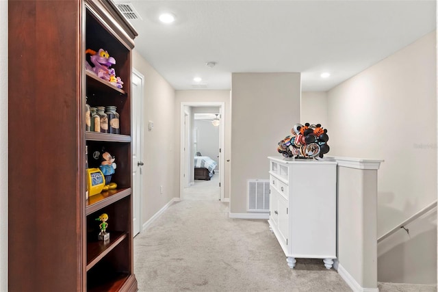 hall featuring light colored carpet