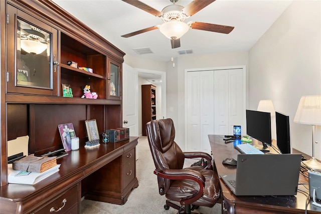 office space with light carpet and ceiling fan