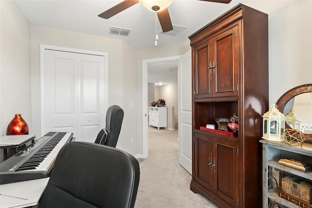 office space featuring light colored carpet and ceiling fan