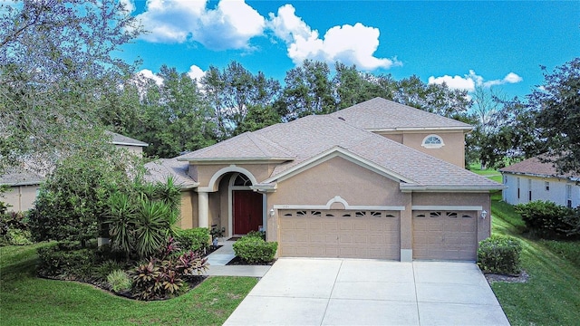 view of front of home with a garage and a front lawn