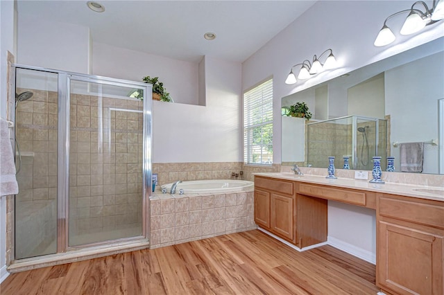 bathroom featuring vanity, plus walk in shower, and hardwood / wood-style floors