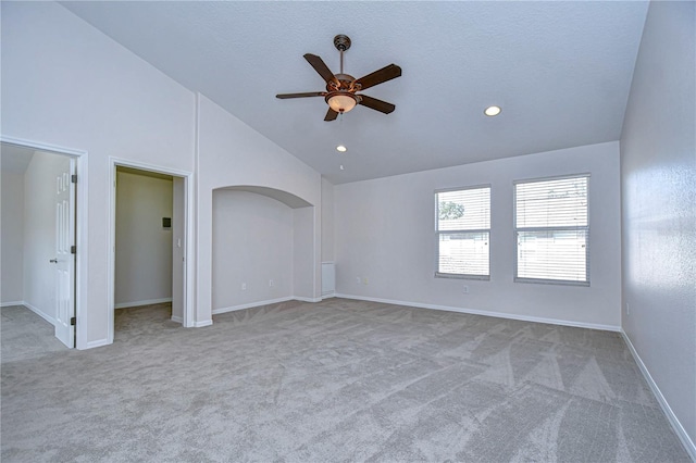 spare room featuring high vaulted ceiling, a textured ceiling, light colored carpet, and ceiling fan