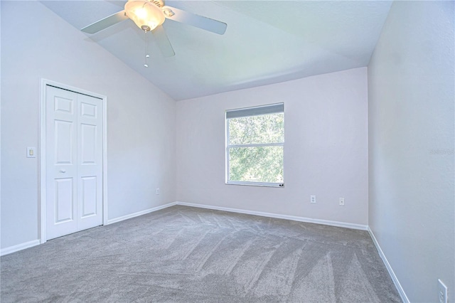 carpeted empty room with lofted ceiling and ceiling fan