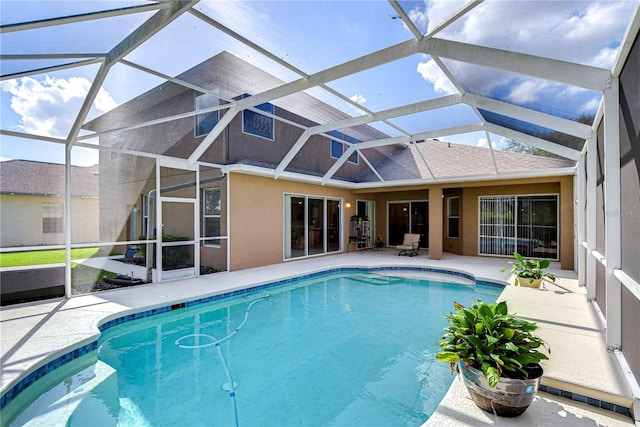 view of pool with a patio and a lanai