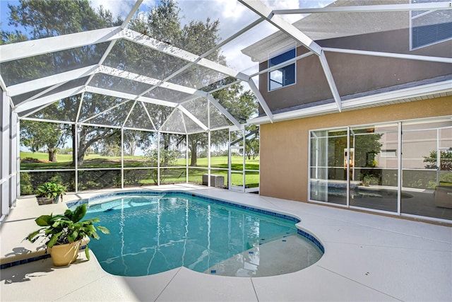 view of swimming pool featuring a patio and glass enclosure