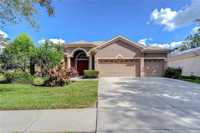 view of front of property with a garage and a front lawn